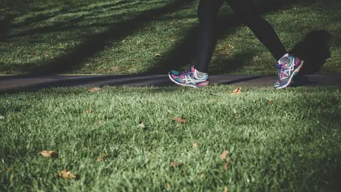 A person walking outdoors as part of an active weekly routine.